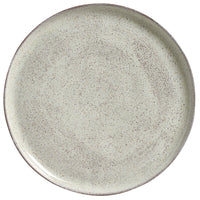 Round ceramic plate with a speckled gray pattern on a white background