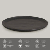 Black round plate on a gray background with safety and feature icons at the bottom.
