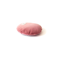 Pink round cushion on a white background