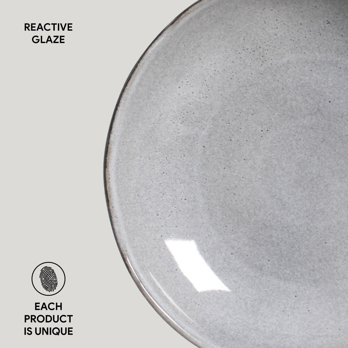 Gray ceramic plate with reactive glaze on a light gray background