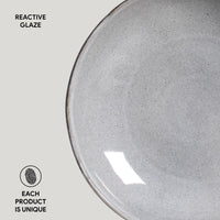 Gray ceramic plate with reactive glaze on a light gray background