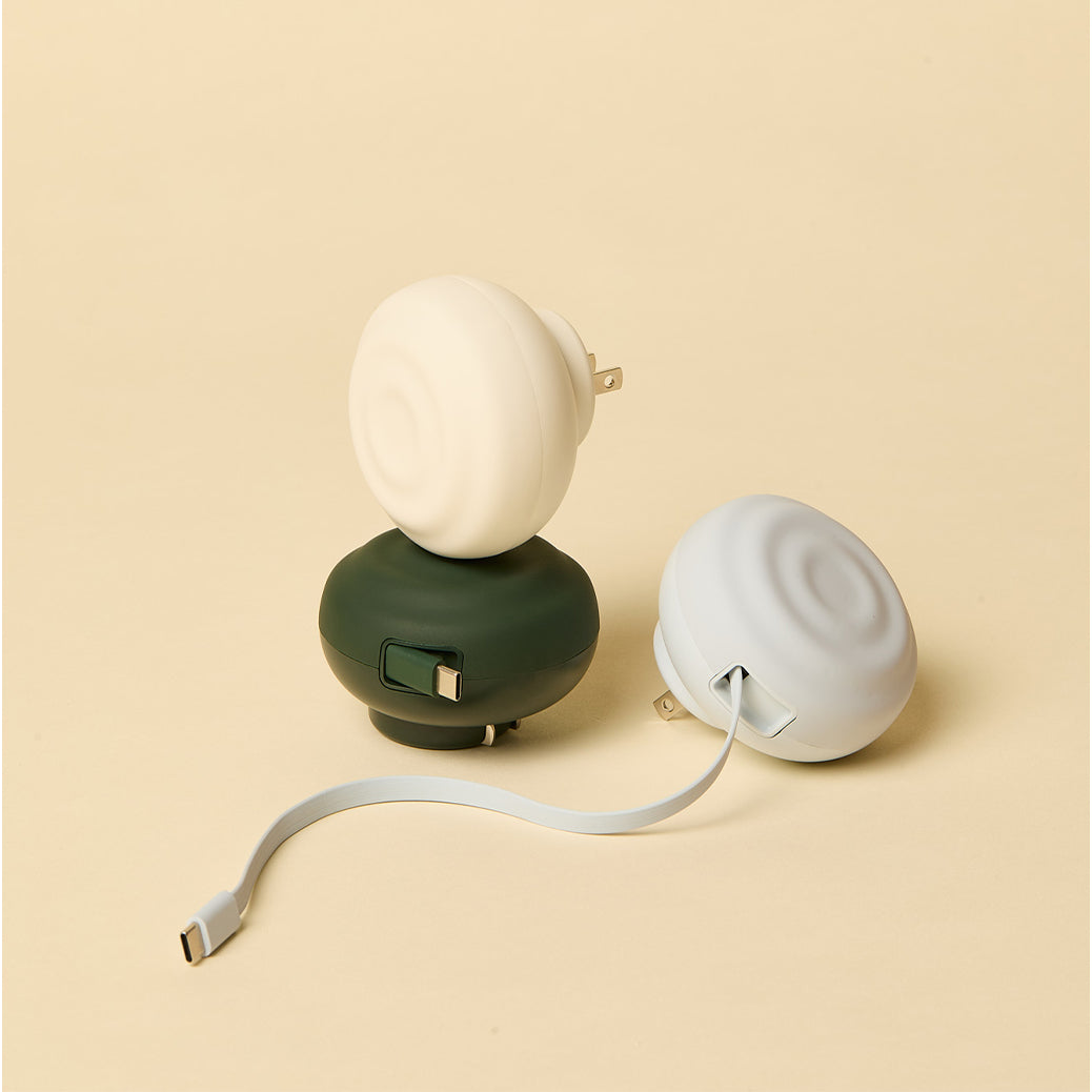 Three small electronic charing devices on a beige background