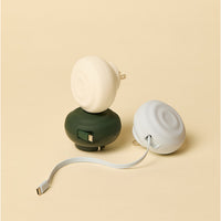 Three small electronic charing devices on a beige background