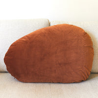 Brown cushion on a beige sofa