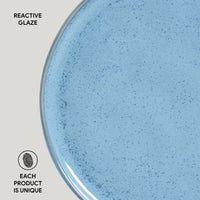 Close-up of a blue ceramic product with reactive glaze on a light gray background