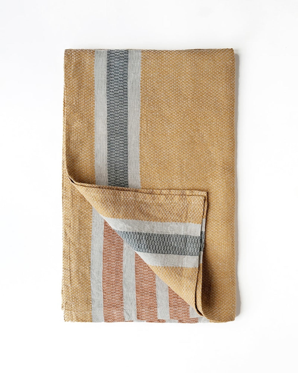 Folded woven towel with striped pattern on a white background