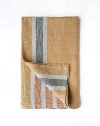 Folded woven towel with striped pattern on a white background