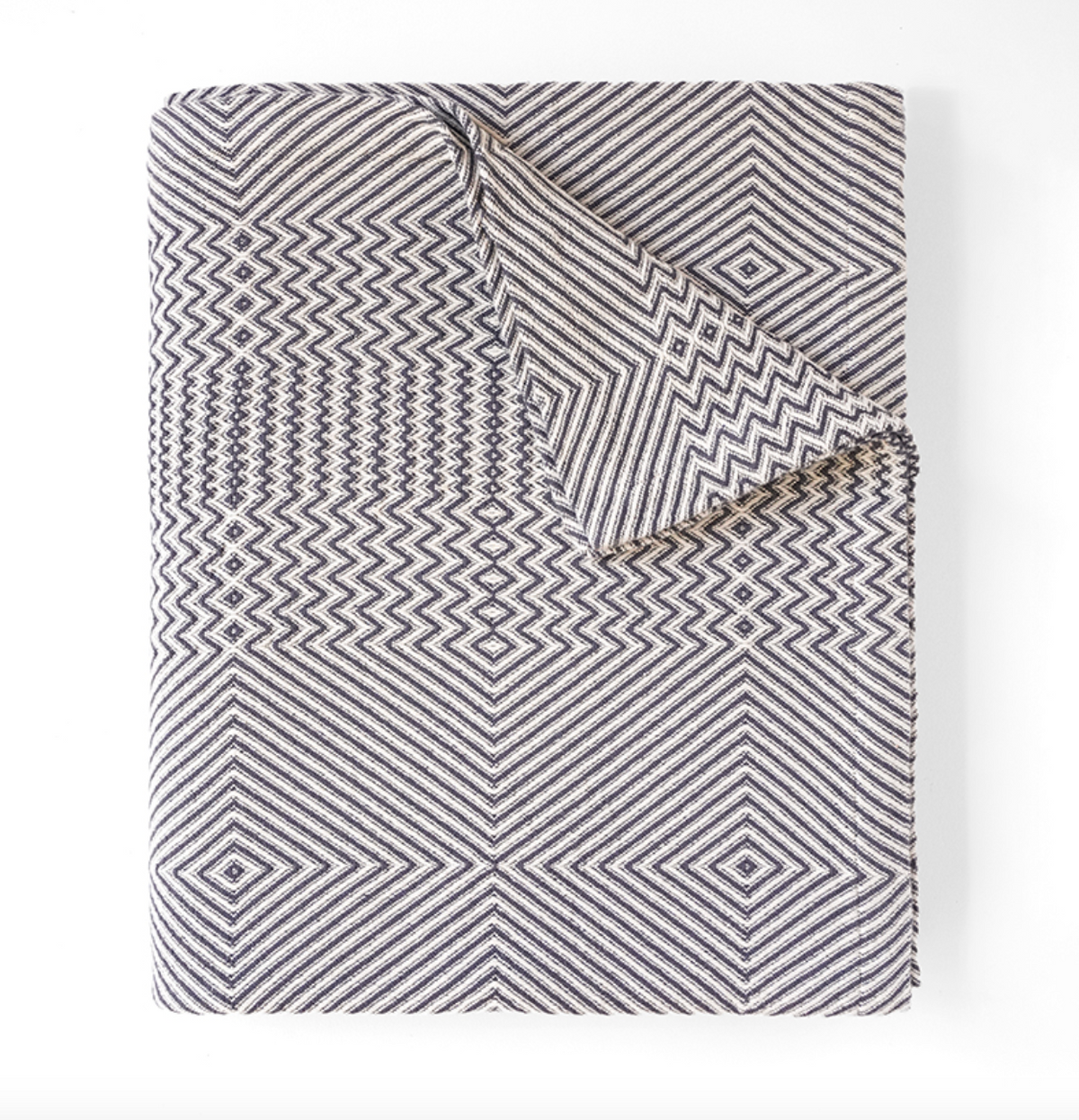 Folded blanket with geometric pattern on a white background