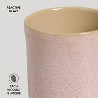 Ceramic mug with reactive glaze on a light gray background