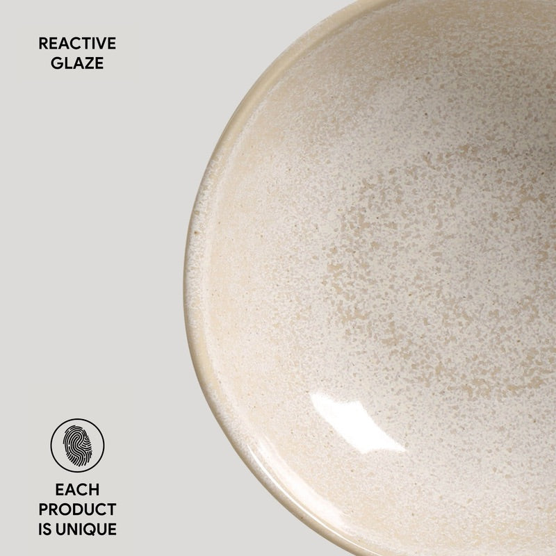 Ceramic bowl with reactive glaze on a light gray background