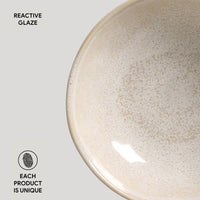 Ceramic bowl with reactive glaze on a light gray background