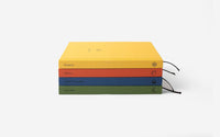 Stack of colorful notebooks on a white background
