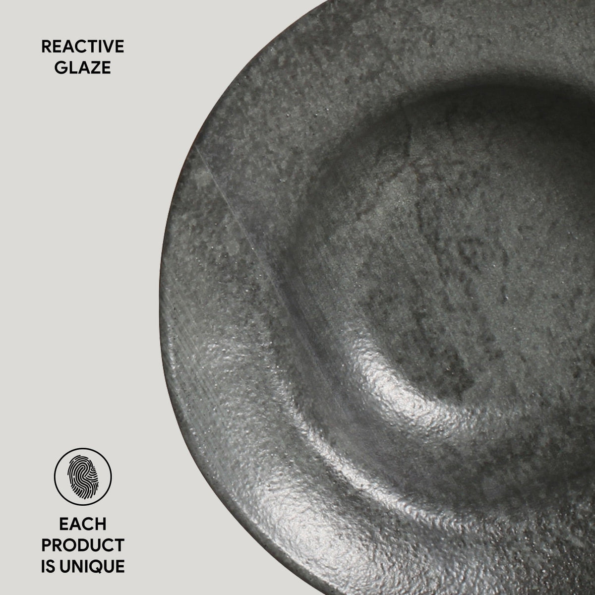 Close-up of a ceramic bowl with reactive glaze on a light gray background