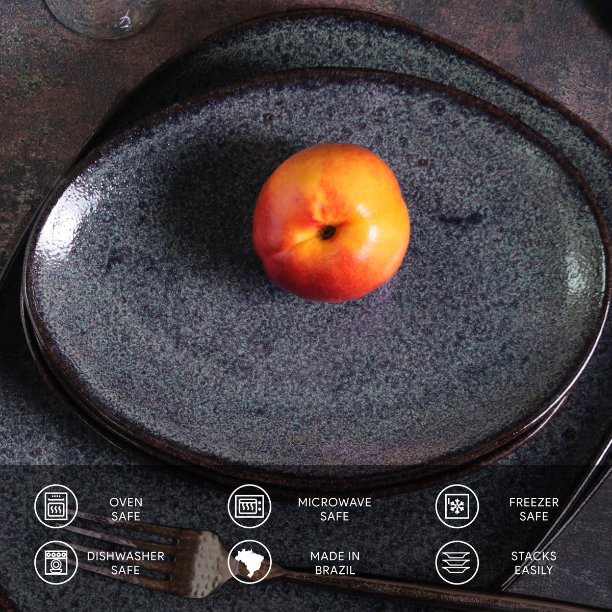Stoneware plate with an apple on a dark surface, featuring safety and feature icons at the bottom.