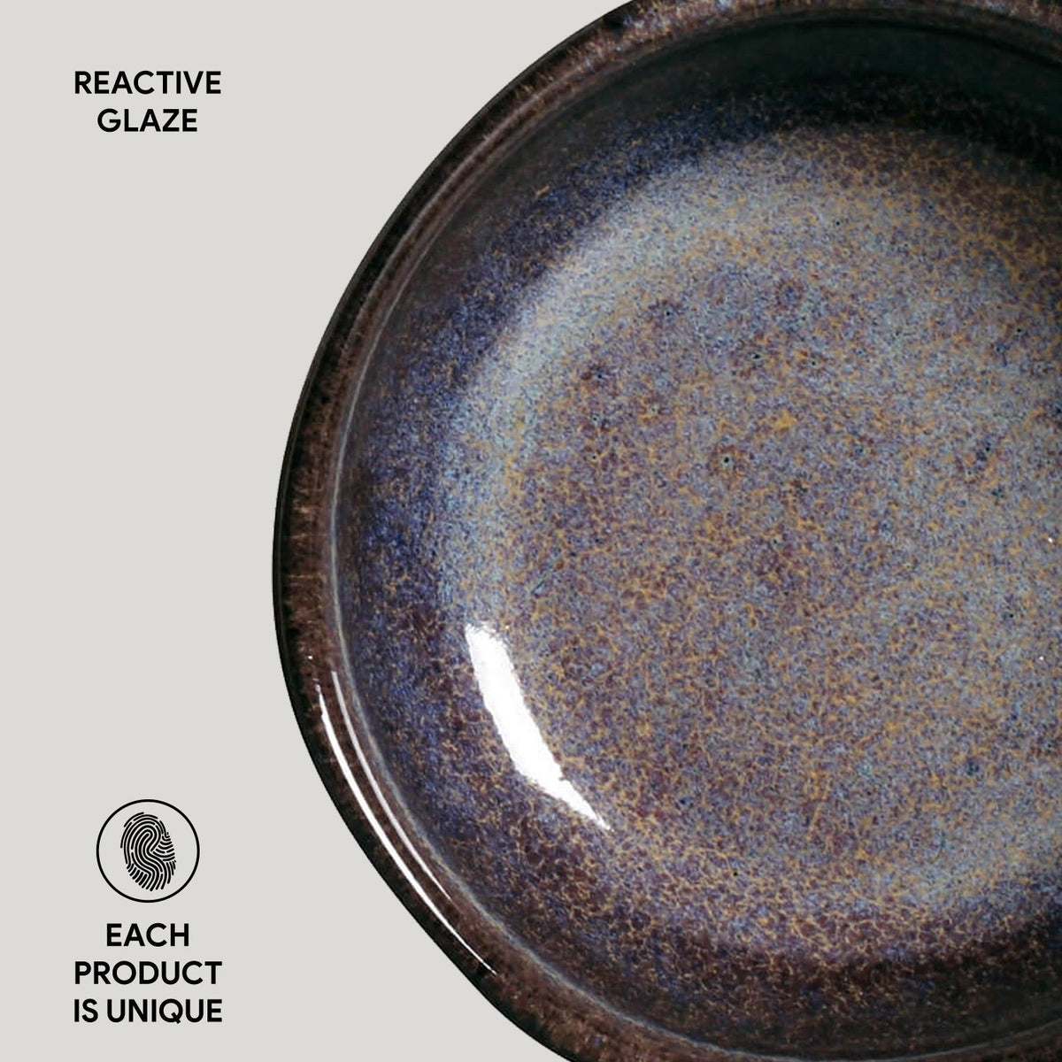 Ceramic plate with reactive glaze on a light gray background