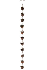Decorative rain chain with copper-colored metal ends on a white background