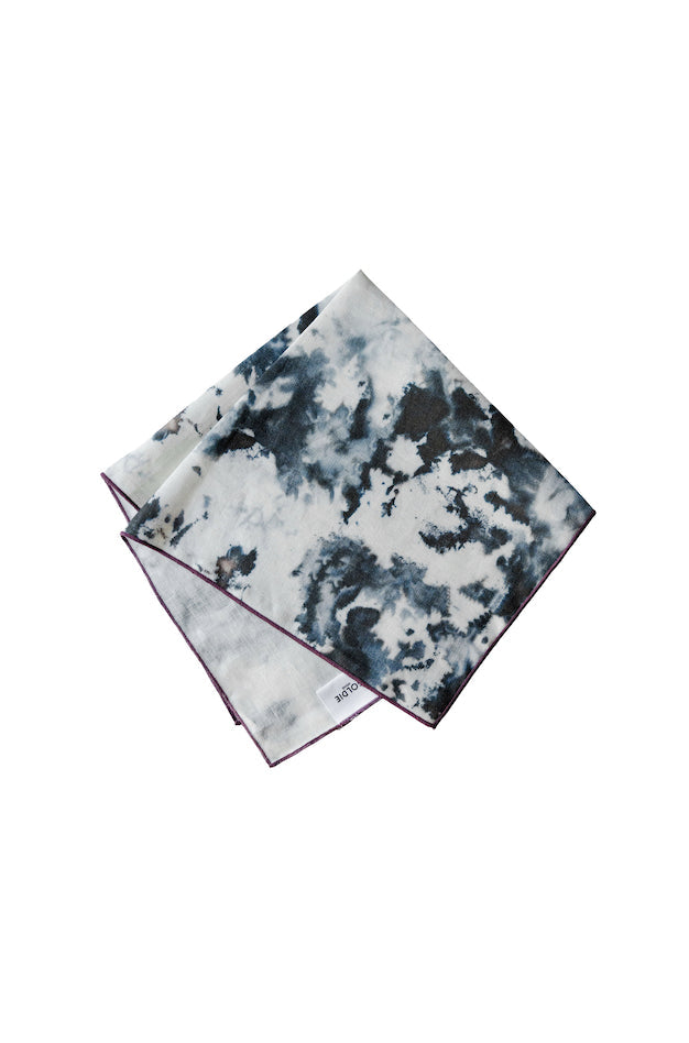 Tie-dye patterned napkin folded on a white background
