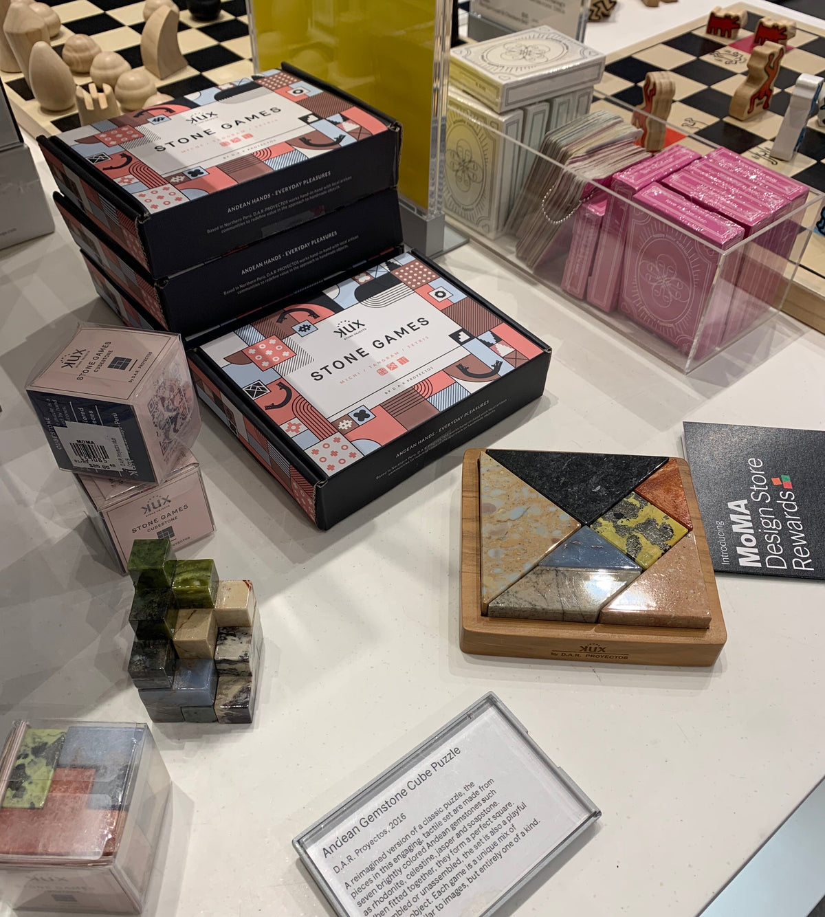 Collection of board games and puzzles on a table with 'MoMA Store' branding.