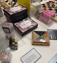 Collection of board games and puzzles on a table with 'MoMA Store' branding.