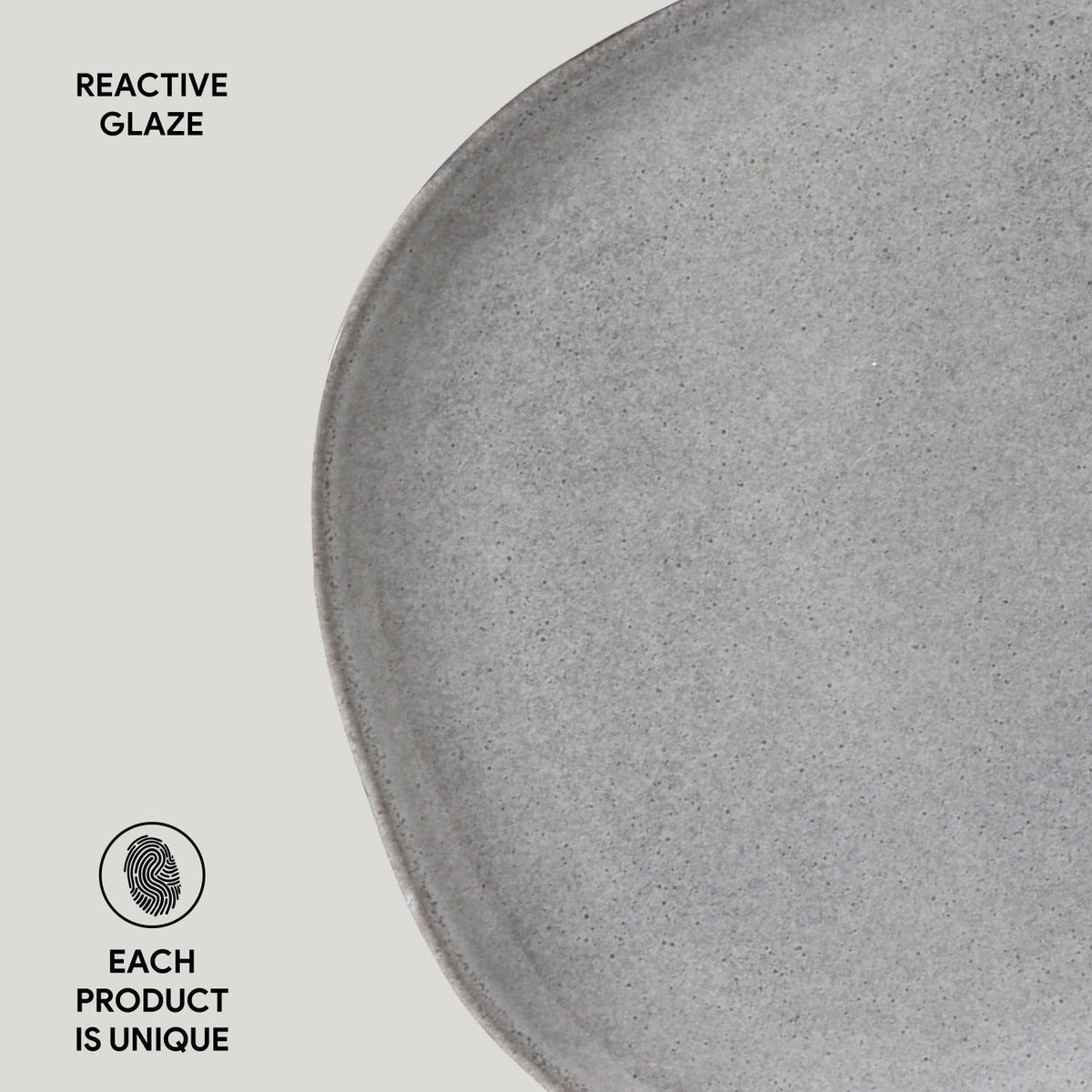 Gray ceramic plate with 'Reactive Glaze' text and 'Each Product is Unique' label on a light gray background