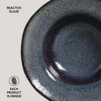 Ceramic plate with reactive glaze on a light gray background