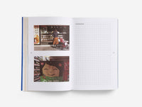 Open book with images and grid pages on a white background