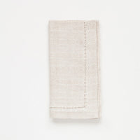 Folded beige napkin on a white background
