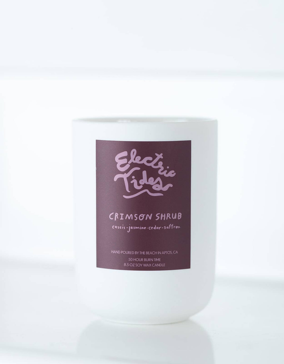 Candle with a purple label on a white background
