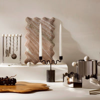 Serveware and home decor styled on a neutral surface