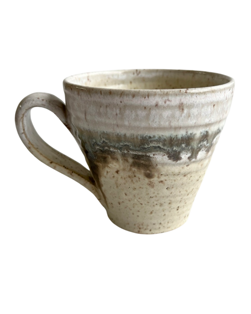 Ceramic mug with light and dark neutral glaze details on a white background