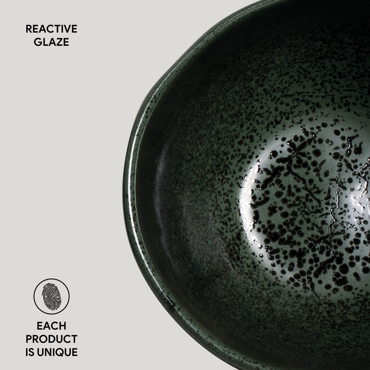 Ceramic bowl with reactive glaze on a light gray background