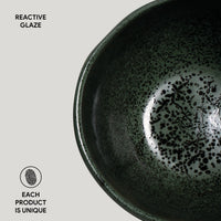 Ceramic bowl with reactive glaze on a light gray background