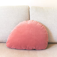 Pink velvet pillow on a beige sofa