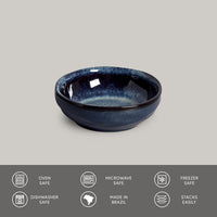 Blue ceramic bowl on a gray background with safety and feature icons at the bottom.