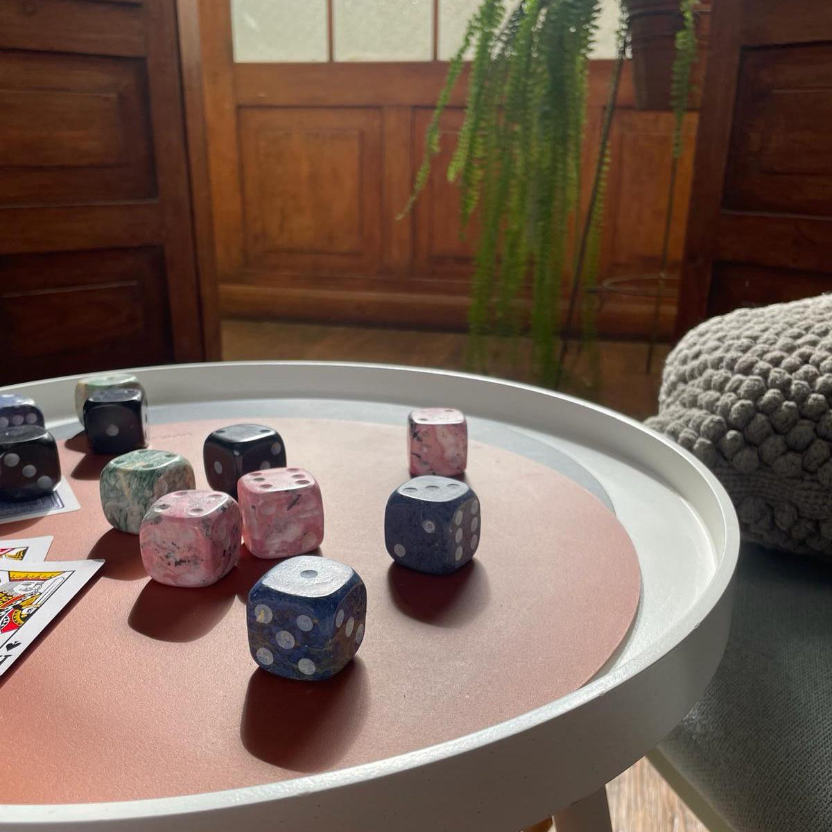 Colorful dice on a round table with a wooden background
