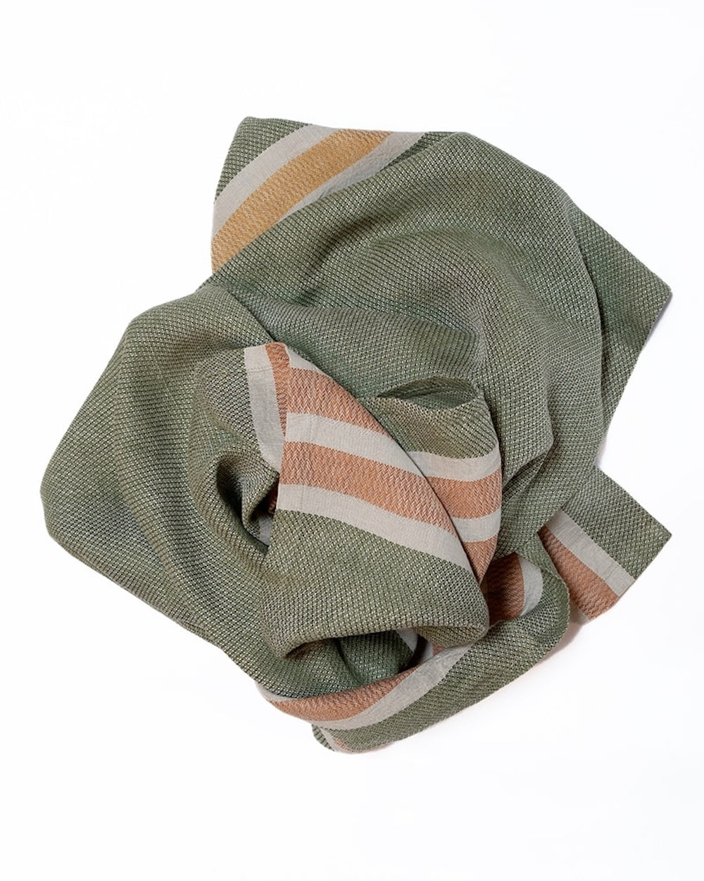 Folded green towel with colorful stripes on a white background