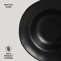 Black ceramic plate with 'Reactive Glaze' text and 'Each Product is Unique' label on a light gray background