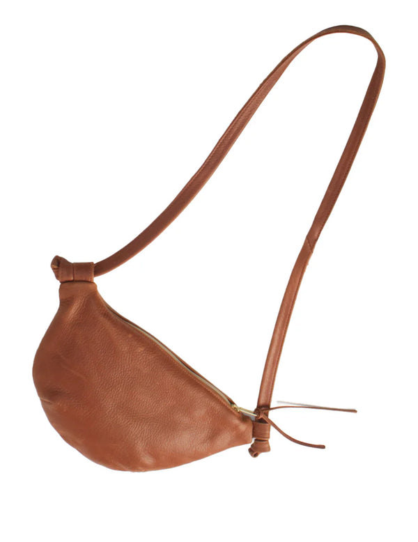 Brown leather bag with a strap on a white background