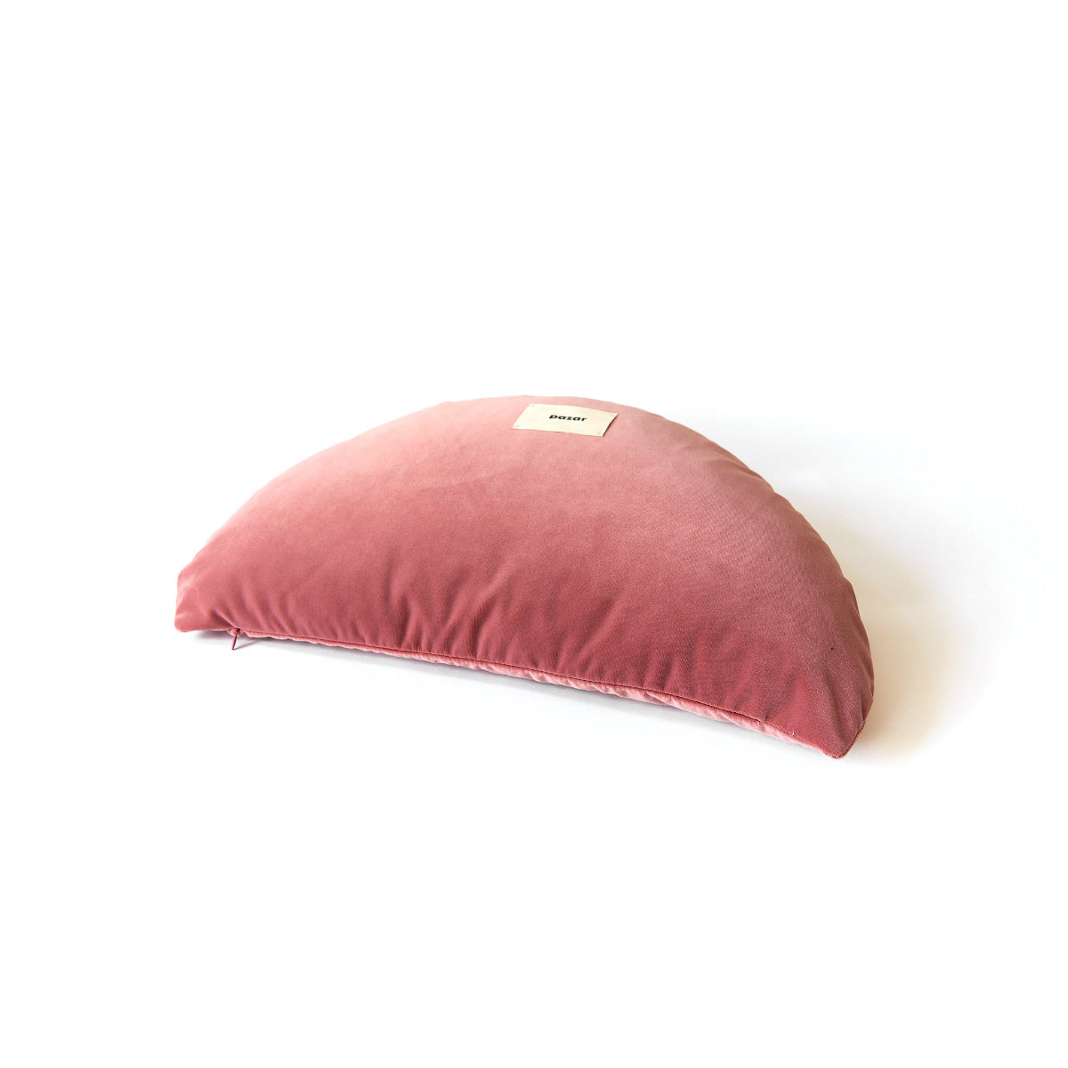 Pink crescent-shaped pillow on a white background