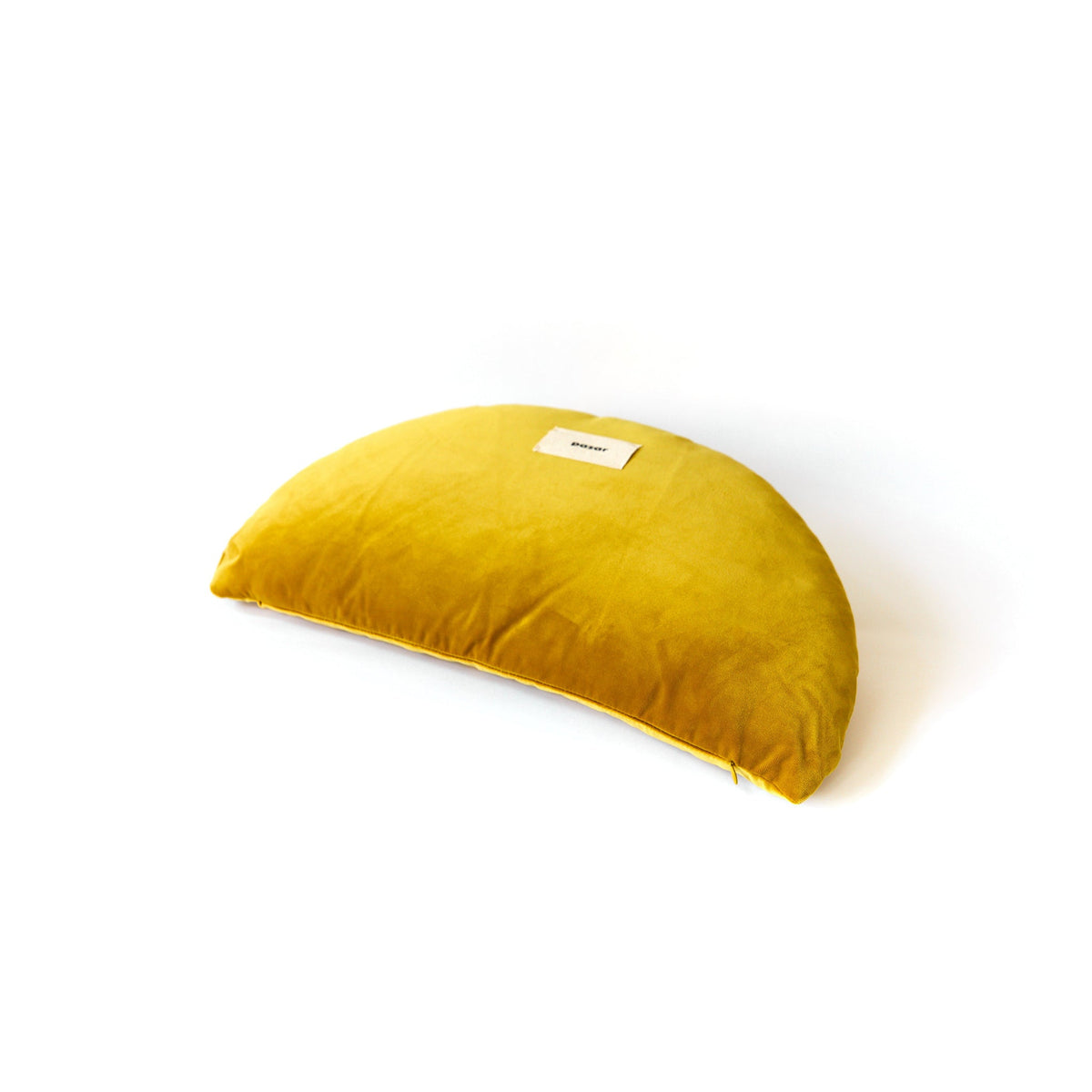 Yellow crescent-shaped pillow on a white background