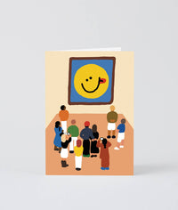 Card with illustration of people looking at a smiley face painting