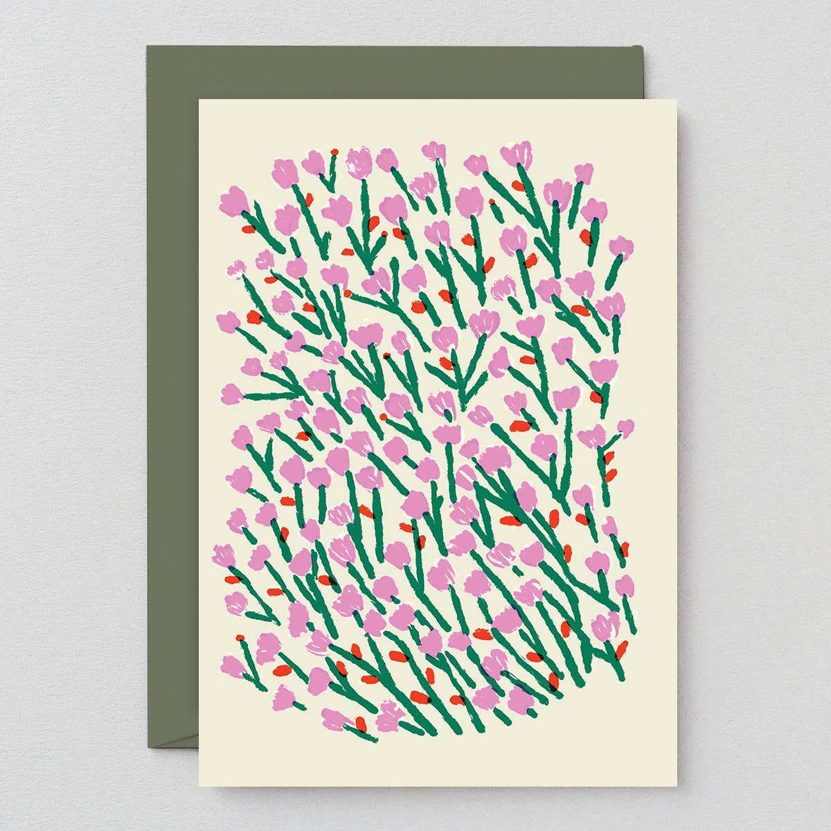 Card with floral pattern and green envelope on light gray background