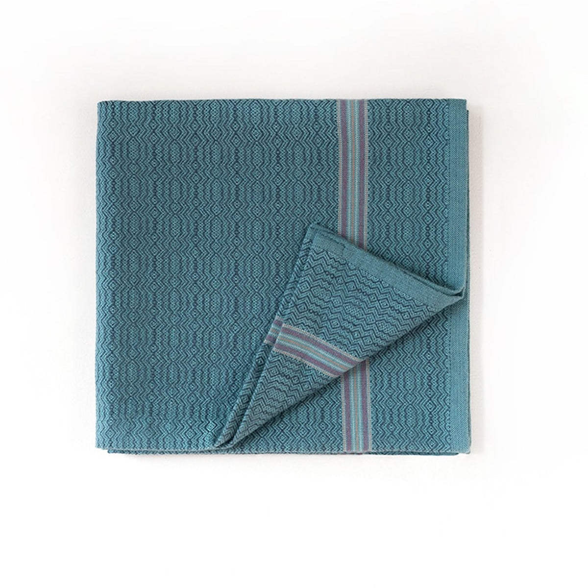 Teal towel with striped border on a white background