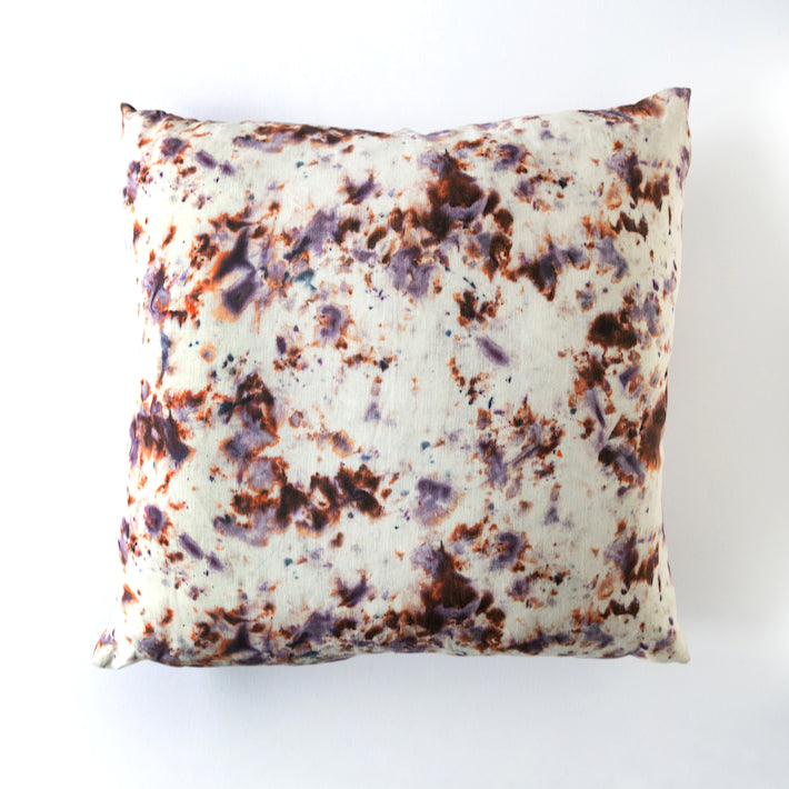 Decorative pillow with a marbled pattern on a white background