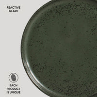 Green ceramic plate with reactive glaze on a white background