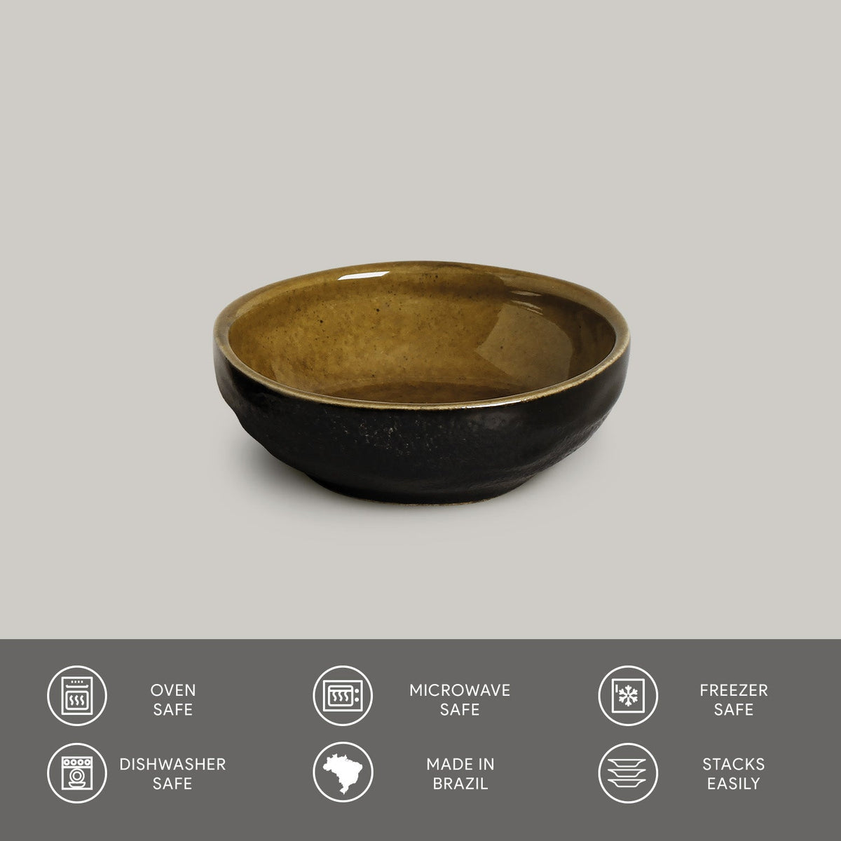 Ceramic bowl with brown interior and black exterior on a gray background