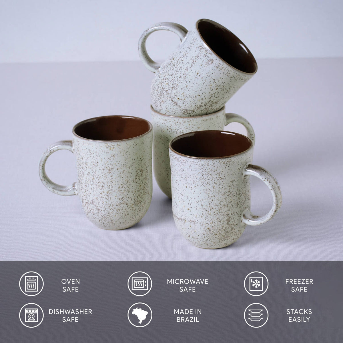 Set of ceramic mugs with speckled design on a light gray background