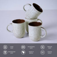 Set of ceramic mugs with speckled design on a light gray background