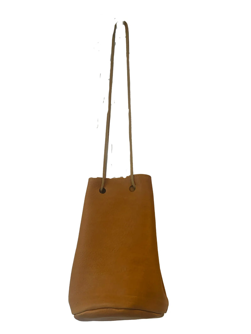 Marigold leather bucket bag with a strap on a white background