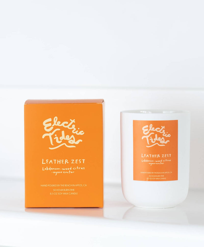 Electric Tides Leather Zest candle and packaging on a white background